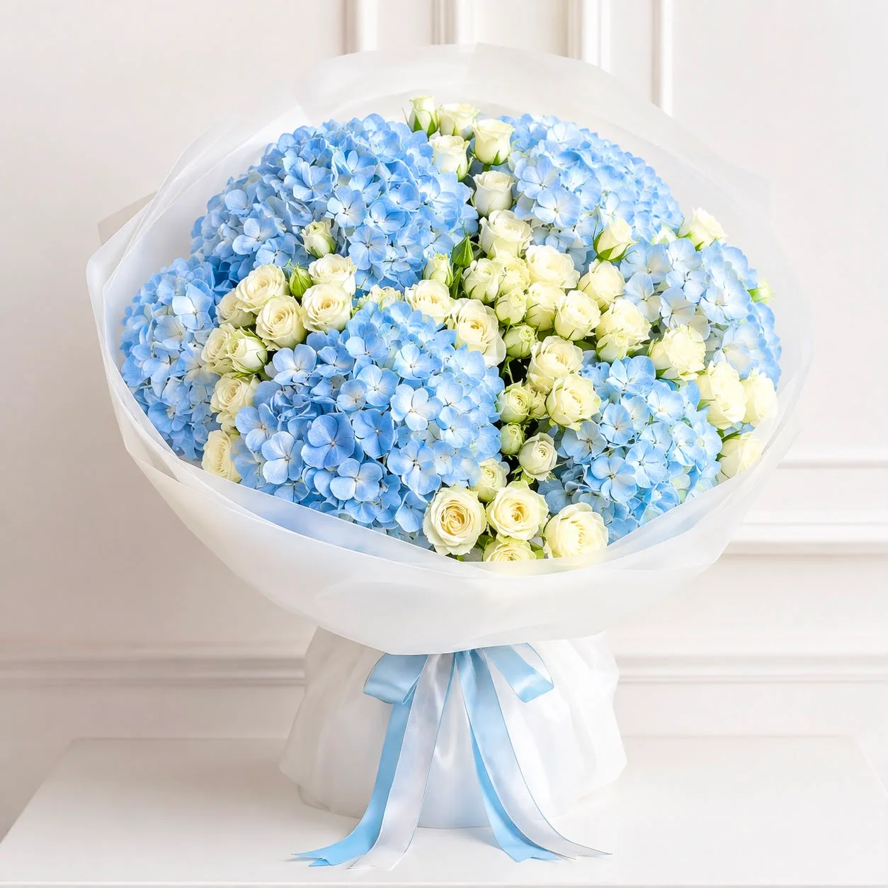 Emirati Women's Day blue hydrangea bouquet with white spray roses expressing strength and lasting respect